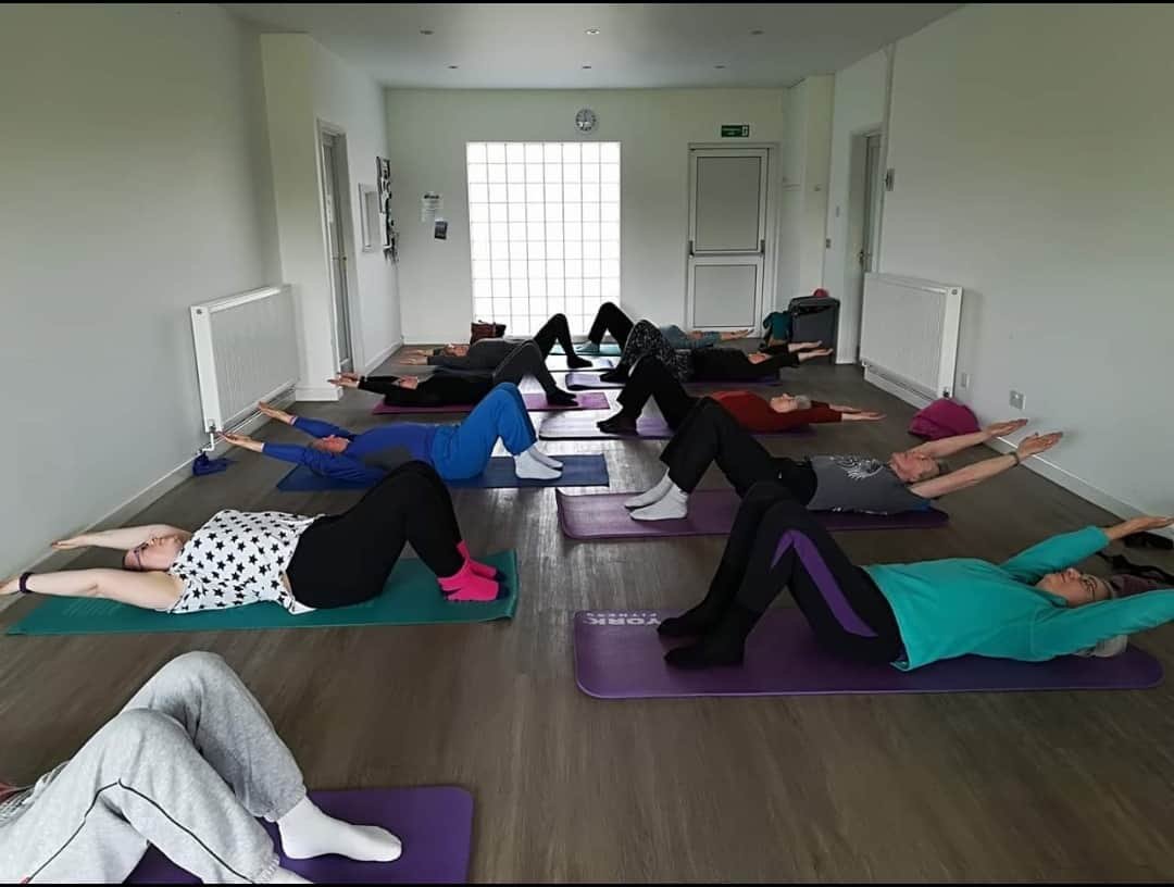 Friendly group exercise class using floor mats